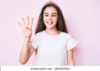 Cute Hispanic Child Girl Wearing Casual Clothes And Diadem Showing And Pointing Up With Fingers Number Four While Smiling Confident And Happy. 