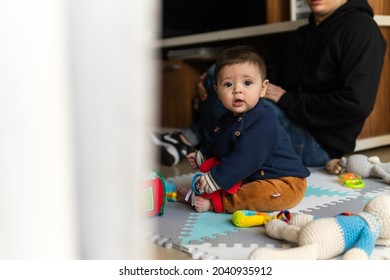 A Cute Hispanic Child Playing With Dad