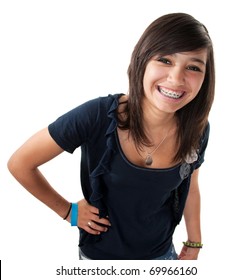 Cute hispanic teenage girl with braces and a big smile while hand on hip