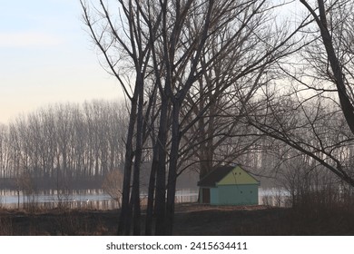 Cute house at the riverside, early morning scene.  - Powered by Shutterstock