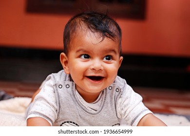 Cute Indian Baby Boy Lying On A Soft Baby Towel With Smile