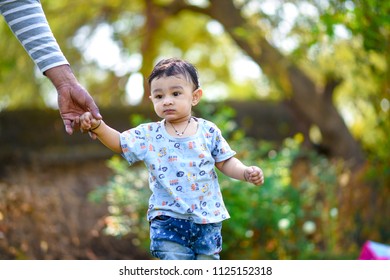 Cute Indian Baby Boy Playing At Garden