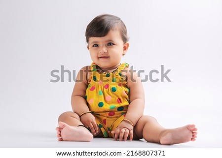 Cute indian baby girl smiling and giving expression.
