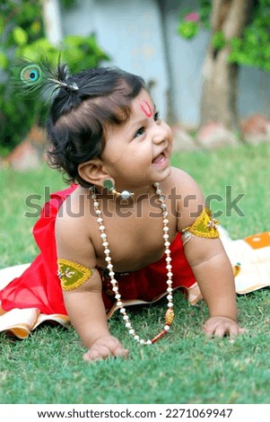 A cute indian boy dressed up in Lord Krishna's avatar. Kanha, Janmastmi. peacock feather. aslso known as Makahn chor