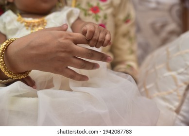 A Cute Indian Child Holding Hand Of Her Grandmother