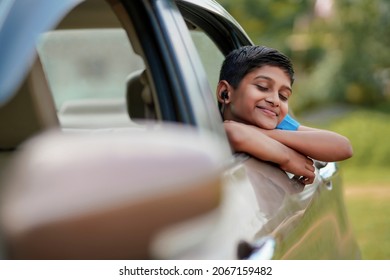 Cute Indian Child Waving From Car Window.