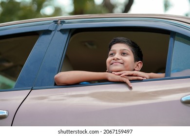 Cute Indian Child Waving From Car Window.