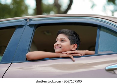 Cute Indian Child Waving From Car Window.