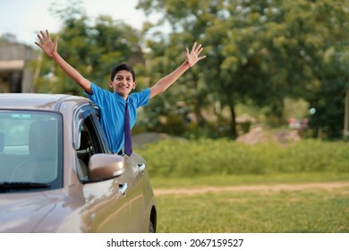 Cute Indian Child Waving From Car Window.