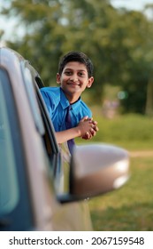 Cute Indian Child Waving From Car Window.