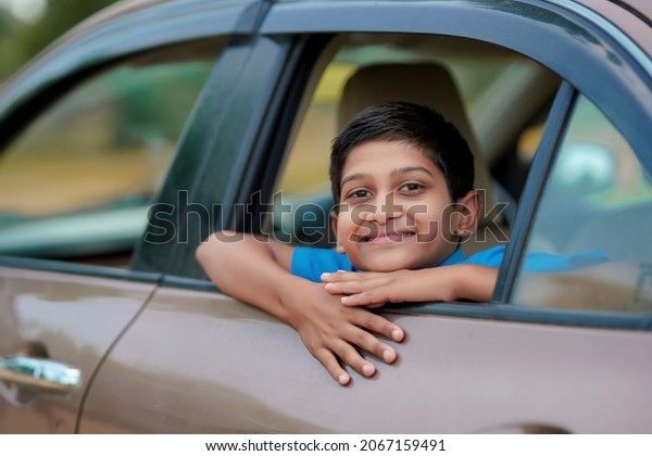 Cute Indian Child
waving from car window.