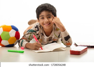 Cute Indian Kid Sketching and Playing, Smiling at the Camera