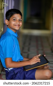 Cute indian little child studying at home