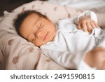 Cute infant baby boy 1-2 months old smiling sleeping in nest close up. Childhood. 