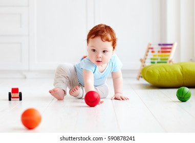 Cute Infant Baby Crawling On The Floor At Home, Playing With Colorful Balls