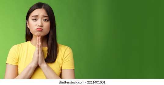 Cute Innocent Needy Asian Girlfriend Begging Help, Asking Favour, Pretty Please, Making Pity Face Pulling Sad Grimace, Frowning Unhappy, Hold Hands Pray, Plead Mercy, Apologizing