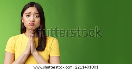 Cute innocent needy asian girlfriend begging help, asking favour, pretty please, making pity face pulling sad grimace, frowning unhappy, hold hands pray, plead mercy, apologizing