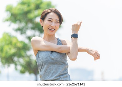 Cute Japanese woman in sportswear - Shutterstock ID 2162691141