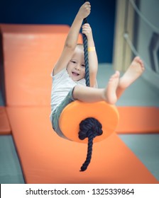 Cute Kid Boy On Zip Line At Playground  