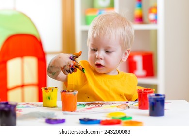 Cute Kid Boy Painting At Home Or Playschool