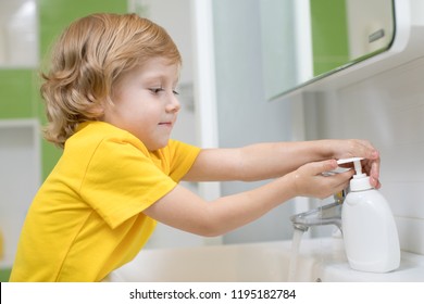 Cute Kid Boy Washing His Hands In Bathroom