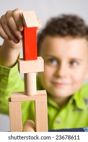 Cute Kid Building A Castle From Wooden Blocks