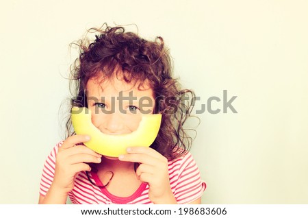 cute kid eating melon. filtered image.