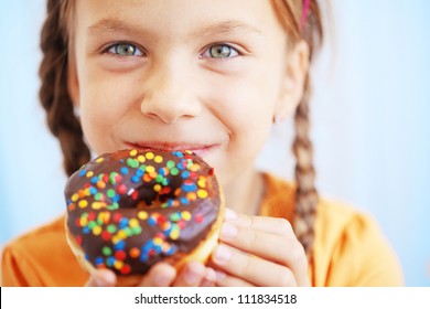 Cute Kid Girl Eating Sweet Donuts