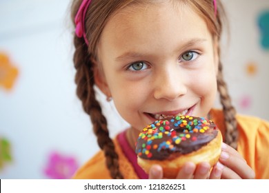 Cute Kid Girl Eating Sweet Donuts