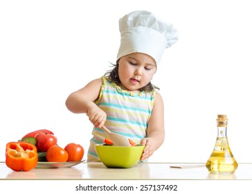 Cute Kid Girl Helping At Kitchen With Salad Making