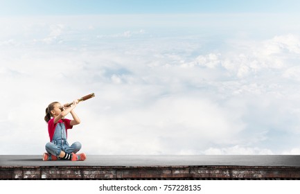 Cute Kid Girl Sitting On House Roof And Looking In Spyglass