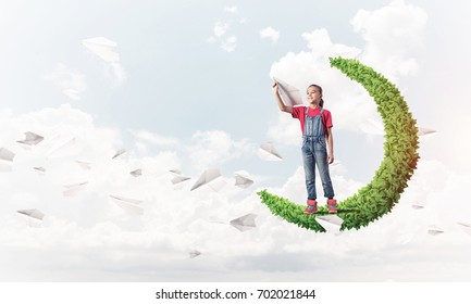 Cute Kid Girl Standing On Green Moon Throwing Paper Plane