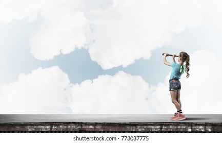 Cute Kid Girl Standing On House Roof And Looking In Spyglass