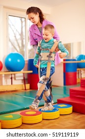 cute kid having physical musculoskeletal therapy in rehabilitation center