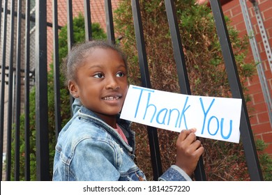 Cute Kid Holding Thank You Sign Outside