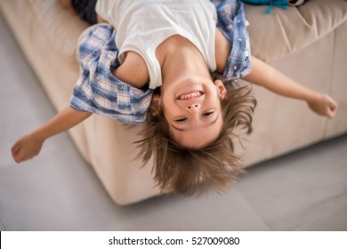 Cute Kid At Home Upside Down Smiling