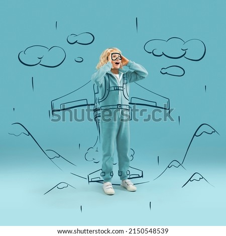 Cute kid, little boy like spaceman with drawn rocket isolated on blue background with pencil sketch. Concept of emotions, ideas, imagination, international children's day. Copy space for ad