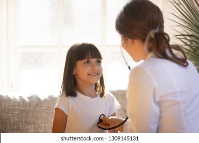 Cute Kid Patient Visiting Female Doctor Pediatrician Nurse Holding Stethoscope Examining Happy Little Child Girl Doing Pediatric Checkup In Hospital Clinic, Children Medical Health Care Concept