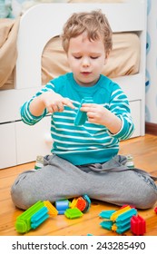 Cute Kid Playing With Colorful Bristle Blocks