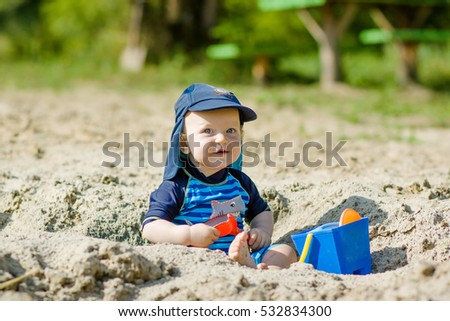 Cute kid playing in the sand  