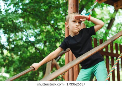 Cute Kid Playing In A Tree House. Summer Vacations, Travel And Leisure. Happy Boy Having Fun At Summer Park. Adventure Park For Kids. Boy In A Treehouse Outdoors.