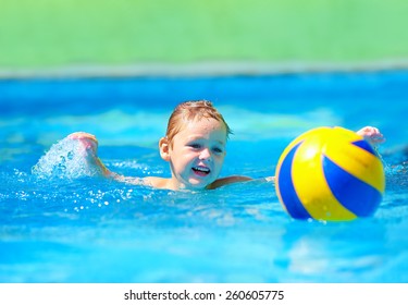 cute kid playing water sport games in pool