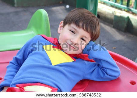 cute kid relaxed with a superhero costume