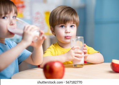 Cute Kids Boys Drinking Milk In Nursery