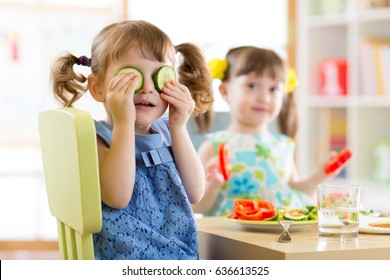 Cute Kids Eating Healthy Food In Kindergarten Or At Home.