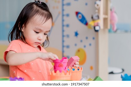 Cute Kids Girls Play With Plastic Toy Kitchen At Home. Soft Focus. Copy Space.