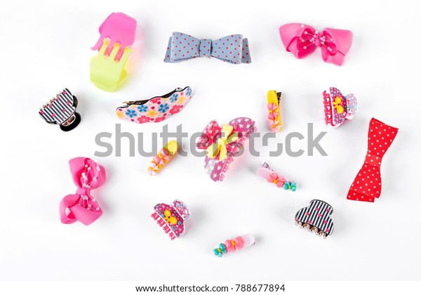 Cute kids hair claws on white background. Hair
clips, hairpins, bow tie on white background. Fashion design hair
accessories for little
girls.