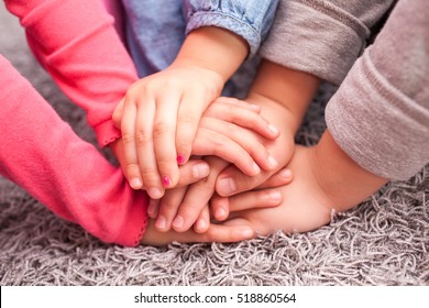 Cute Kids Hands Together On Gray Wool Carpet, Cheering Pose