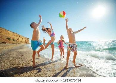 Cute Kids Having Fun On The Sandy Beach In Summer. High Quality Photo.