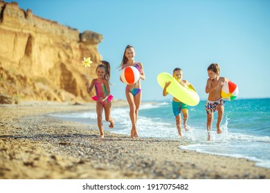 Cute kids having fun on the sandy beach in summer. High quality photo. - Powered by Shutterstock